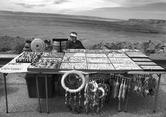 Jewelry vender with  Colorado River and Vermillian Cliffs in  background, Arizona
